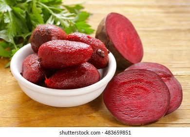 ripe boiled pickled beets for salad on a wooden table