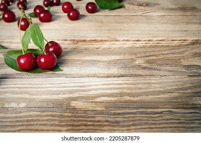 Ripe of cherries on wooden background with copy space - Shutterstock ID 2205287879