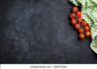 Ripe Cherry Tomatoes Over Stone Kitchen Table. Top View With Copy Space