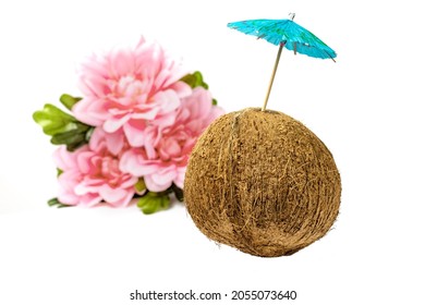 A Ripe Coconut With A Pink Flower And A Cocktail Umbrella Suggesting Making A Tropical Drink Like A Pina Colad