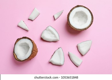 Ripe coconuts on color background, top view