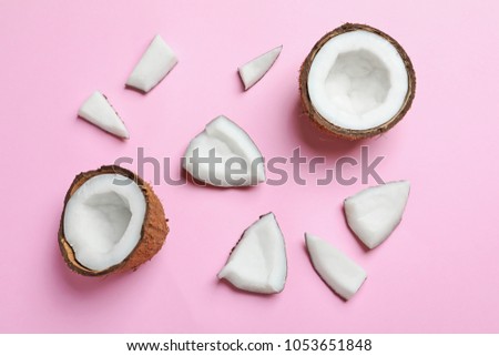 Ripe coconuts on color background, top view