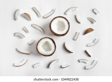 Ripe coconuts on white background, top view