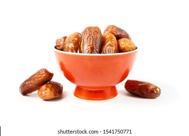 Ripe date palm fruits in brown bowl on white background, close up
