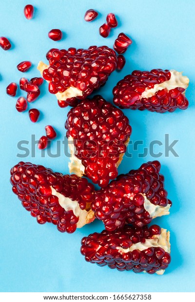 ripe and\
delicious grains of ordinary red pomegranate, close-up of the\
ripened crop divided into individual\
grains