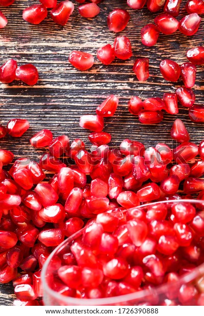 ripe and\
delicious grains of ordinary red pomegranate, close-up of the\
ripened crop divided into individual\
grains