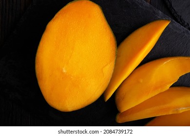 Ripe egyption Mango slices served  at black dish. close up - Powered by Shutterstock