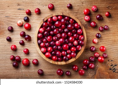 Ripe fresh cranberry in wooden bowl on rustic table top view. - Shutterstock ID 1524584330
