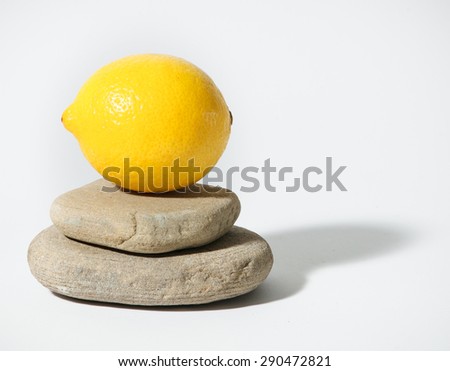 Ripe and fresh lemon on flat stones