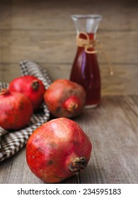 Ripe fruits of pomegranate and juice on the table - Shutterstock ID 234595183