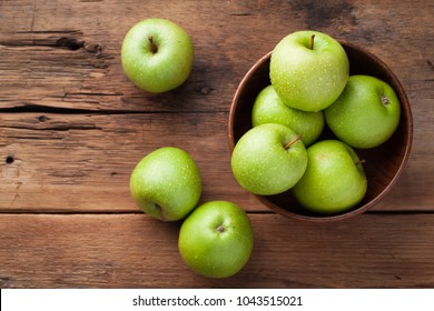 Ripe green apples in a wooden bowl on an old rustic table. Useful fruits on wooden background. Top view with copy space - Powered by Shutterstock