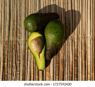 Ripe Green Avocado, Lie On A Reed Mat. View From Above. Harvest Concept. 