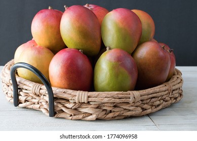 Ripe and green mangoes in basket