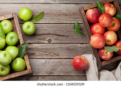 Ripe green and red apples in wooden box. Top view with space for your text