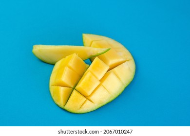 Ripe And Juicy Mango Cut With A Net With A Wedge. Side View