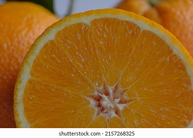 ripe and juicy orange. fresh orange cut in half on a background of oranges