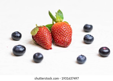 Ripe And Juicy Strawberries And Blueberries On A White Background. Healthy Eating