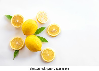 Ripe Lemon And Slices With Leaves Isolated On White Background,Flat Lay.
