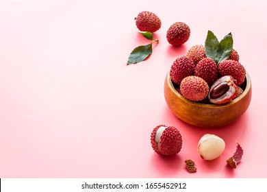 Ripe lychee. Exotic asian fruits in bowl on pink desk copy space