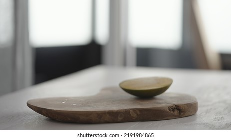 Ripe Mango On Olive Board On White Oak Table