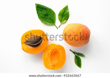 Ripe orange apricots with leaves on white background. Isolated fruit. 