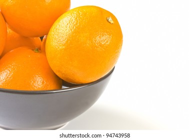 Ripe Oranges In A Black Bowl