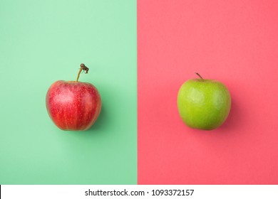 Ripe Organic Apples on Split Duotone Green Red Cherry Pink Background. Styled Creative Image. Vitamins Summer Vegan Fashion Concept. Food Poster with Copy Space