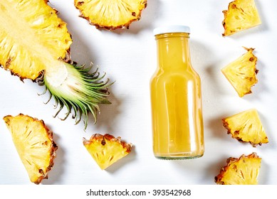 Ripe Pineapple Slices And Juice Over White Background. Top View