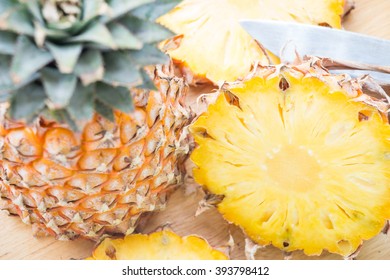 Ripe pineapple slices on wooden cutting board - Powered by Shutterstock