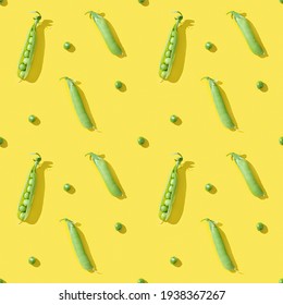 Ripe pod of green pea with small round peas on yellow background. Organic healthy food. Creative pattern.