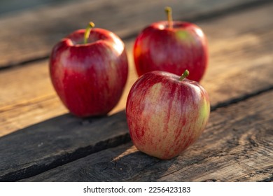 Ripe red apples on wooden background . - Shutterstock ID 2256423183