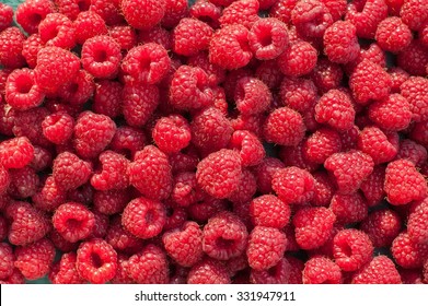Lot ripe red raspberries as background