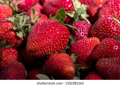 Ripe red strawberry on the market, background. Useful berries from the garden, growing at home