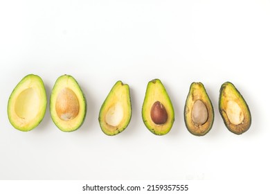 Ripe and spoiled rotten fruit vegetables avocado in a cut, white background, copy space