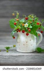 Ripe strawberries, bouquet in a small white jug