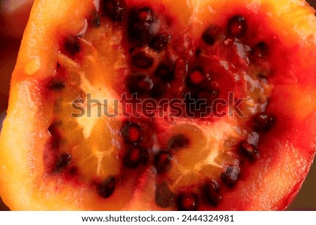 Ripe tamarillo fruit meat close-up cross-section texture as a backdrop composition