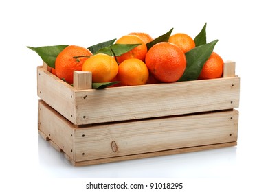 Ripe tasty tangerines with leaves in wooden box isolated on white - Shutterstock ID 91018295