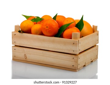 Ripe tasty tangerines with leaves in wooden box isolated on white - Shutterstock ID 91329227