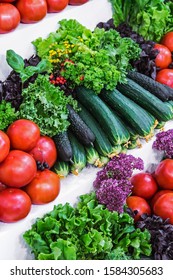 Ripe Tomatoes And Cucumbers With Salad On The Store Counter. Background Of Vegetable Harvest