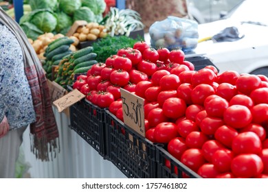 Ripe tomatoes on the counter of the Belarussian market. Fresh vegetables in the street bazaar. Small tomatoes.