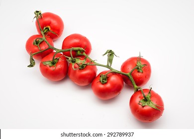 Ripe Tomatoes On The Vine Isolated On White