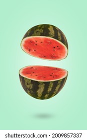 Ripe watermelon cut in half flying in the air. Floating, flying, levitating sliced fresh watermelon on a green background. Creative and abstract food concept.