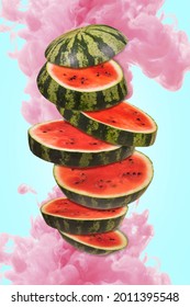 Ripe watermelon cut into pieces flying in the air, with a pink paint splash. Floating, flying, levitating sliced fresh watermelon with splash of water on a blue background. 
