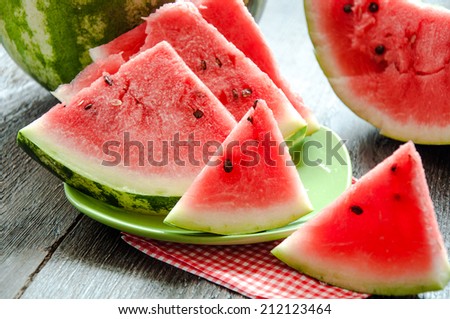 Ripe watermelons on table on wooden background