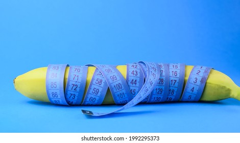 Ripe Yellow Banana Wrapped In A Centimeter On A Colored Background. Concept Of Healthy Food, Fitness, Diet, Weight Loss. Selective Focus.