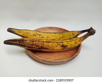 Ripe Yellow Plantain On Wooden Plate With White Background