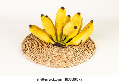 Ripen Yellow Sour bananas on a woven mat - Powered by Shutterstock