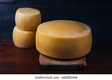 ripening handmade rural cheese on a wooden table - Powered by Shutterstock