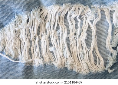Ripped denim. Coarse blue cotton threads - Shutterstock ID 2151184489