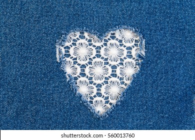 Ripped denim heart frame on Destroyed torn blue jeans on white lace background. Denim jeans fashion background  - Powered by Shutterstock